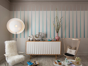 Neutral with blue pop scandi dining room with fur chair and plant with blue stripes on wall